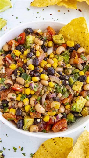 This Cowboy Caviar recipe is a vibrant bean salad with lots of beans and fresh ingredients tossed in a tangy vinaigrette, perfect for any party. This version with extra jalapeno peppers and additional spices makes it better than any I've ever had. >> Comment “RECIPE" and I'll send this recipe straight to your DMs! 🥳 RECIPE: https://www.chilipeppermadness.com/recipes/the-ultimate-cowboy-caviar/ Cowboy Caviar Ingredients: FOR THE DRESSING/VINAIGRETTE: 1/4 cup olive oil 1/4 cup apple cider vinegar