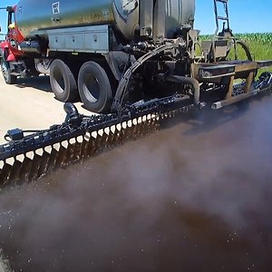 Watching these trucks spray asphalt is oddly satisfying 😲 | In The Know