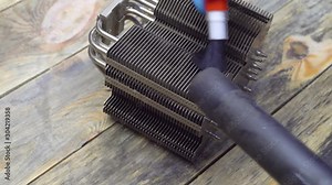 Old computer system unit cooler with dust inside. Dust on the computer, cooler, computer processor, the master removes it with a brush and a vacuum cleaner.
