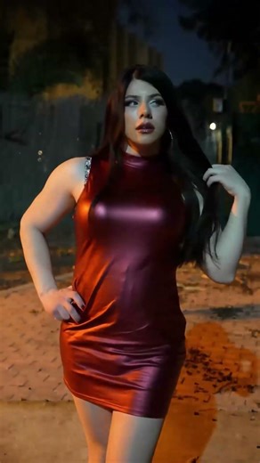 Crossdressing outdoors in leather red dress