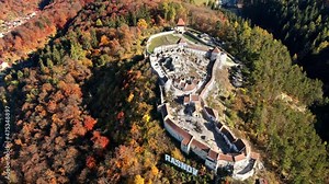 Aerial drone view of The Rasnov Fortress in Romania. Medieval fortress with Rasnov inscription on the top of the hill, tourists