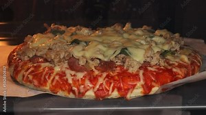 homemade Margherita pizza with cheese and tomatoes. Time lapse video of baking pizza in the oven. Close-up melting cheese