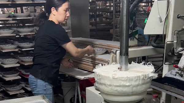 Machine in ceramic factory uses soft stamper to print beautiful designs onto dishes