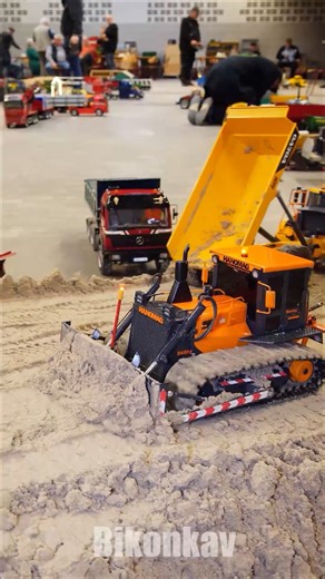 RC dozers and dump trucks create a bridge ramp