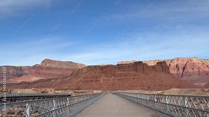 View across the old historic Navajo Bridge at Marble Canyon across the Colorado River. The stunning Vermillion Cliffs can be seen on the other side of the bridge - Arizona, USA