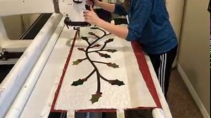 9.5K views · 256 reactions | Here's the perfect Holly table runner that you can complete in minutes (once it's cut out). We love making projects from start to finish on the longarm frame! Kristina shows how to make a festive holly table runner. You will LOVE it! Customize the size and shape to fit your table. Easy-peasy. | Handi Quilter | Facebook