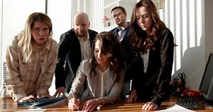 A diverse and driven group of colleagues discuss their project in the office, using stickers to visualize their ideas. Advertise this video for workplace diversity, inclusivity, or employee engagement