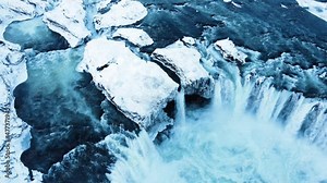 Godafoss aerial shot, famous waterfall in Iceland, Frozen waterfall in winter, a magical winter location of snow and ice, Pure glacial water with a huge current