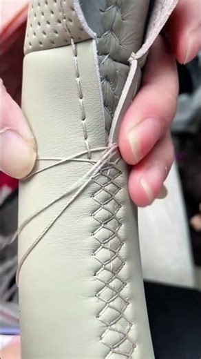 Meticulously Hand-Stitching a Leather Steering Wheel Cover with a Cross-Stitch Pattern