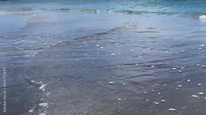 Waves on black sand beach from Nevis Peak Volcano. Pinney's Beach (Pinneys Beach) on western coast of the island of Nevis, in Saint Kitts and Nevis, Leeward Islands, West Indies in the Caribbean Sea.