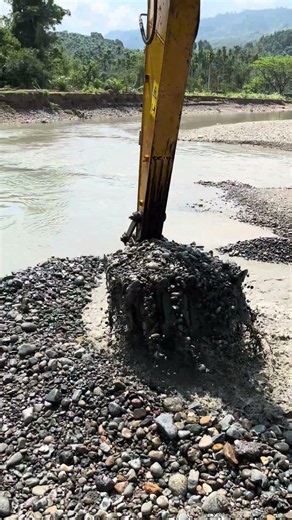 POV: Excavator Working at the River Edge