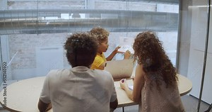 African American woman in an office showing some graphics to the employees. Office, coworkink, start-up