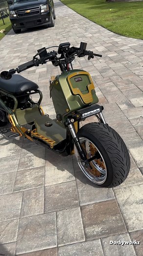 Dorby on Instagram: "Ruckus Golden 💛 Tank From the battleground to the open road, this Honda Ruckus has emerged as a true warrior. 🛡️ ✨ Check out this stunning custom build, sporting captivating Green Pearl paint, a fatty front wide wheel, and bulletproof Kevlar accents. It’s a sight to behold! 💪 Under the hood, a powerful built 171R engine roars to life, while full performance upgrades in suspension ensure a smooth and thrilling ride. 🏆 But what truly sets this Ruckus apart is its resilienc