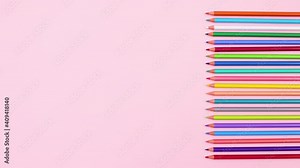 Pencils in different colors appear on right side of pastel pink theme. Stop motion