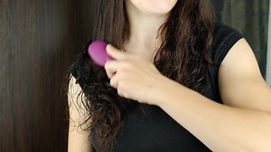 woman brushing her hair after shower