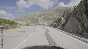 Driving a car on the Gotthard Pass from South to North Switzerland. Amazing Views of the swiss alps and the mountains from the Cars point of view. Famous Gotthardpass or Passo del San Gottardo.