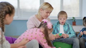 female teacher working with young children with down syndrome constitute constructor for mental development in an inclusive classroom