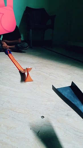 Child Playing with Hot Wheels Toy Car on Track