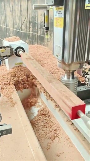 CNC router sculpts wood beam, shavings cascade in rhythmic precision