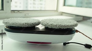 Replacing the microfiber on the window cleaner robot with a clean one. State of the art window cleaner, close-up