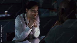 Female police detective questioning a crime suspect & showing him evidence