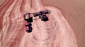 A combine unloads wheat onto a grain cart during the Palouse wheat harvest of Eastern Washington