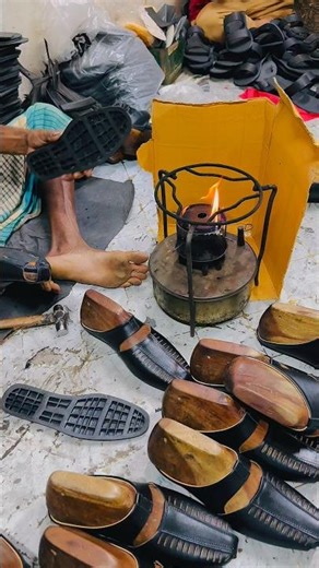 Shoe soles are being applied by hand with a check over fire.