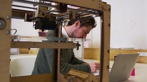 clip-17913136-designer-working-beside-3d-printer-design-studio