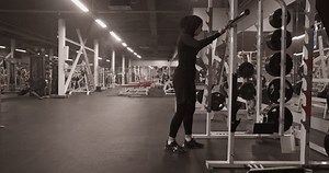 Female athlete squatting with barbell