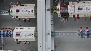 An electric switchboard with modules for protection and control of electrical loads, mounted on din rails.