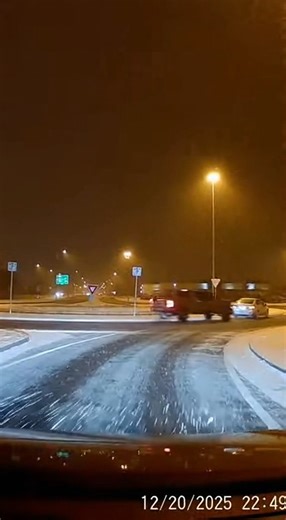 Lifted Truck Enters Roundabout at High Speed, Triggering Multiple Vehicle Collisions Cleveland, Ohio Dash camera footage shows a snow-covered roundabout slick with ice, lane markings barely visible beneath packed snow and slush. Traffic approaches cautiously, brake lights glowing as vehicles slow to navigate the circular intersection under poor traction. Moments into the clip, a lifted pickup truck enters the roundabout at excessive speed, ignoring the yield and cutting sharply across the icy su