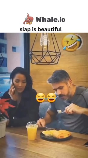 @justviralsttuf on Instagram: "- The post features a 30-second video clip of a woman slapping her male partner at a restaurant after he repeatedly tries to feed her despite her refusals, captioned “slap is beautiful!” to portray the act as empowering and humorous. - With 11,700 likes and 1.2 million views in two days, it sparks debate in replies, highlighting perceived double standards in gender-based violence, as users note the clip would be condemned as abusive if roles were reversed. - Posted