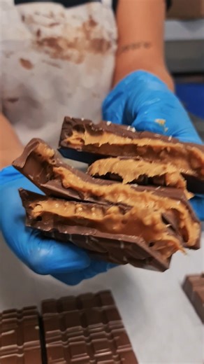 3.9K views · 15 reactions | ✨ What’s hiding inside? ✨ Watch as we layer silky caramel, creamy peanut butter, crunchy roasted peanuts, and rich couverture chocolate to create our Caramel Peanut Crunch Bliss Block. The result? A block that’s as irresistible as it looks, smooth, nutty, and utterly blissful. 樂癩  Tag someone who loves caramel as much as you do and try this blissful block today! #PoppysChocolate #BlissBlocks #Chocolates | Poppy's Chocolate | Facebook