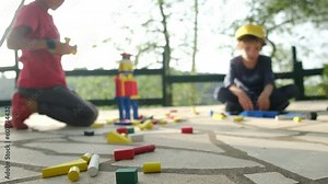 Delve into the world of hands-on learning with this captivating stock video on Adobe Stock. Join two children in their playful exploration as they construct vibrant wooden towers using construction fi
