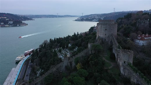 Aerial shot of a castle on a hill in a seaside town - Free Stock Video