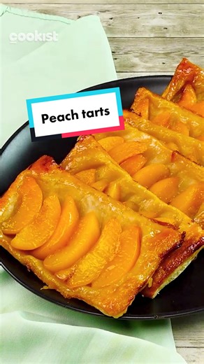 Here's how to make a #sweet #treat in minutes! 😍 Save this recipe: 👉INGREDIENTS Puff pastry Honey Peach Beaten egg Powdered sugar 👉METHOD 1. Pour a little honey on a baking tray, spread with a spoon, and place peach slices in a row. 2. Place a piece of puff pastry on top, and press down the edges with your fingers. Brush the top with milk. 3. Bake for 16 minutes at 180°C (356°F). 4. Turn over and sprinkle with powdered sugar to serve. What fruit would you use instead? 😋👇 #cookistwow #cookis