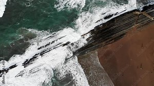 Aerial drone view of famous flysch of Zumaia, Basque Country, Spain. Flysch is a sequence of sedimentary rock layers that progress from deep-water