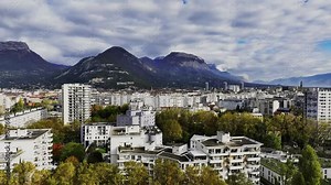Grenoble and its buildings under the Chartreuse massif in the French Alps aerial view