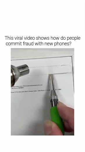 ✈️ on Instagram: "The post's attached video demonstrates a phone fraud method by showing how scammers use tools to scrape off barcodes and QR codes on iPhone 17 Pro Max packaging, allowing replacement with falsified identifiers to sell refurbished or fake devices as new. It quotes a separate viral clip of a worker operating a hazardous rotating machine to process paper stacks, captioned to highlight the risk of fingers getting caught, creating a stark contrast between physical and digital danger