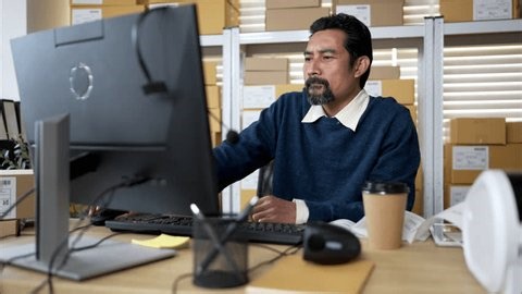 clip-3970713377-small-business-owner-working-late-warehouse-office