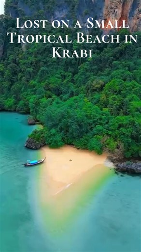 Lost on a Small Tropical Beach in Krabi 🌴🌊✨ Hidden between towering limestone cliffs and the emerald waters of the Andaman Sea lies one of Krabi’s most enchanting secrets, a tiny, tucked-away tropical beach where time seems to pause. This little paradise, often missed by hurried travellers, reveals the quieter, softer side of Krabi’s coastline. With silky sand underfoot, long-tail boats resting gently on the water, and palms swaying lazily in the warm breeze, it becomes the perfect escape for 
