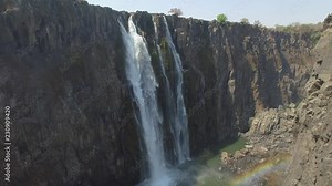Beautiful fall and rainbow inside the canyon at Victoria falls, drone view