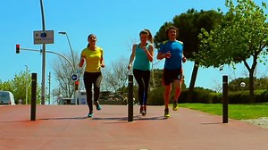 Group of friends running in the city, slow motion shot