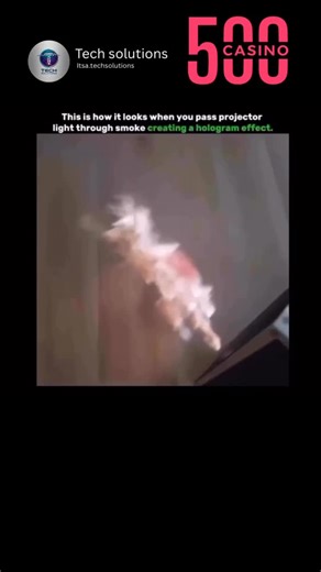 Tech solutions on Instagram: "This is how it looks when projector light passes through smoke, creating a mesmerizing hologram-like effect. When fine smoke particles fill the air, they act as tiny reflective surfaces. As the projector’s beam hits these particles, the light scatters in all directions, making the projected image appear to float in mid-air. This gives the illusion of a glowing, three-dimensional hologram that shifts and dances with the movement of the smoke. It’s a simple yet stunni