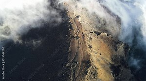 Drone footage of the summit of the Piton des Neiges in the clouds at the Reunion island.