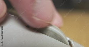 Dirty mouse wheel. A finger twists the center button of a computer mouse. Macro photography, close-up.