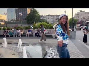 in a summer fountain in jeans