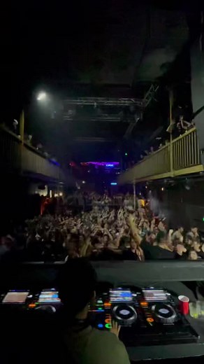 DJ Energizes Nightclub Crowd with Dynamic Performance