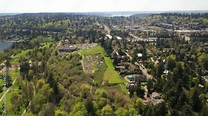 Cinematic 4K drone orbiting footage of downtown Mercer island, Beaumont, Luther Burbank Park, residential and commercial areas, luxury, beachfront homes by Lake Washington, near Seattle , King County