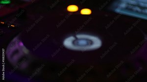 Audio control panel close-up at the concert during the performance. The buttons are lit by different colors.